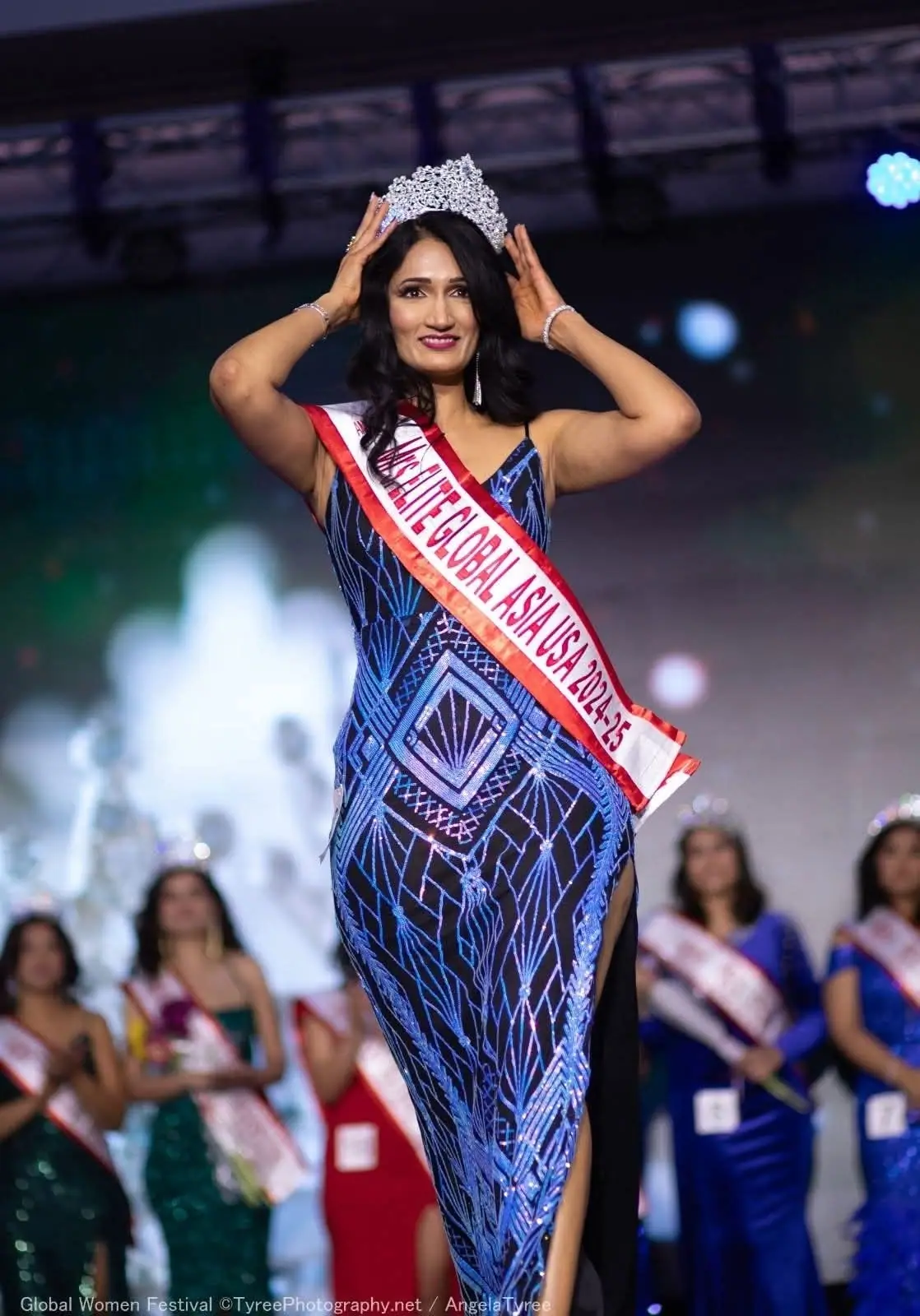 A crowned Global Asia titleholder receiving recognition on stage