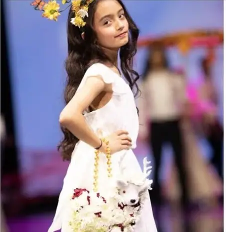 Preema Desai, Miss Pre-Teen Universal North America, on the runway in a white dress