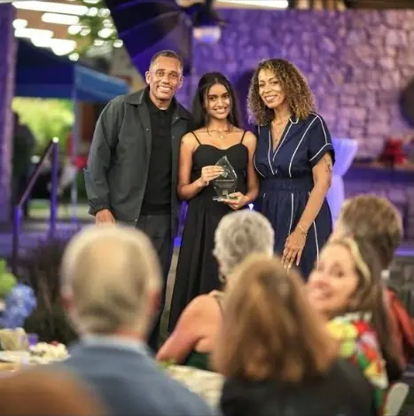 Mudra Machewad, Miss Teen India Washington, holding her Lifesaver Achievement Award with Hill Harper